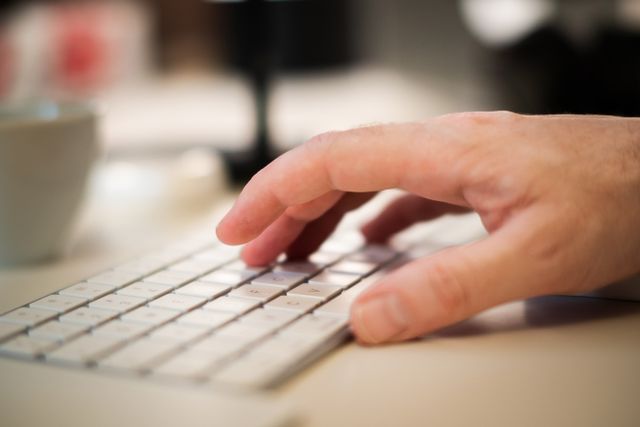 a person typing on a keyboard
